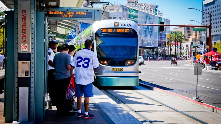 Diamondbacks fans riding Valley Metro Rail Baseball fans waiting for light rail to arrive