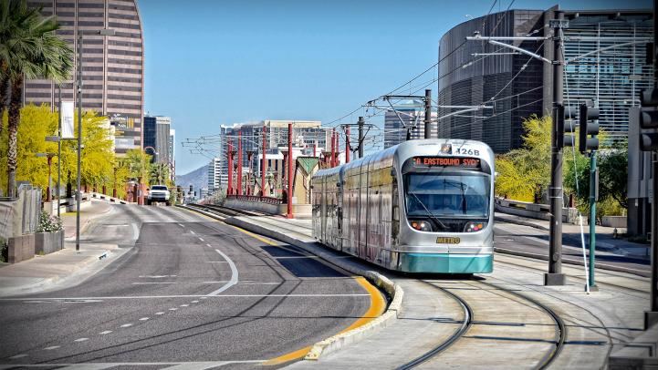 A light rail train rounds a corner
