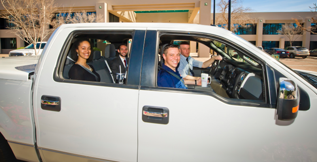 Picture of a carpool, four people sitting in a vehicle.