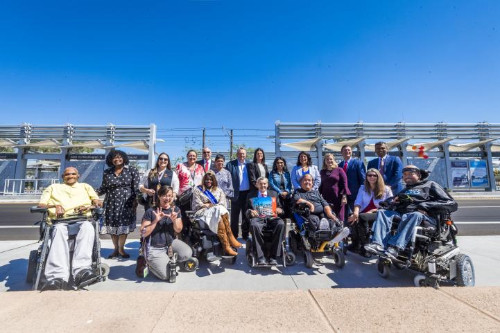 A group of riders gather to celebrate the 50th Street Station opening