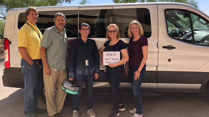 American Express employees standing by their van