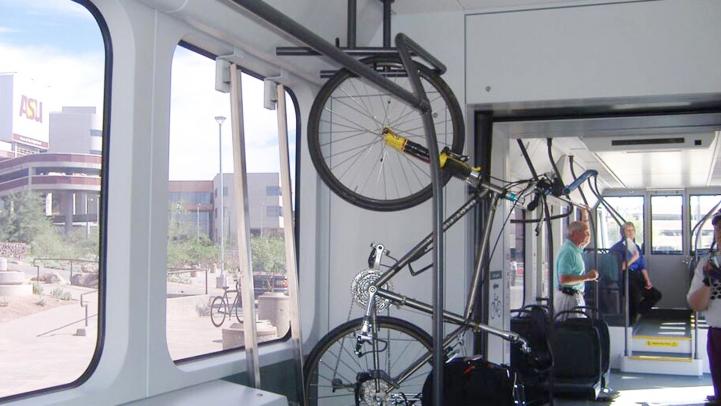 A bicycle propped up on a rack in a train