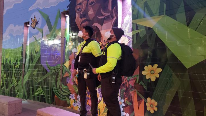 CECs pause in front of a mural