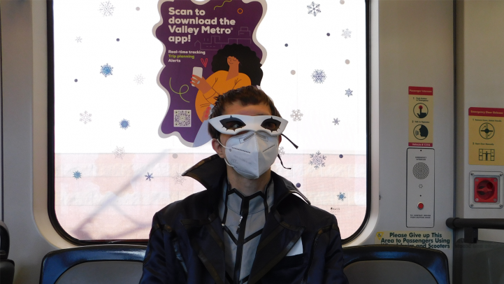 Cosplayer sitting on light rail train
