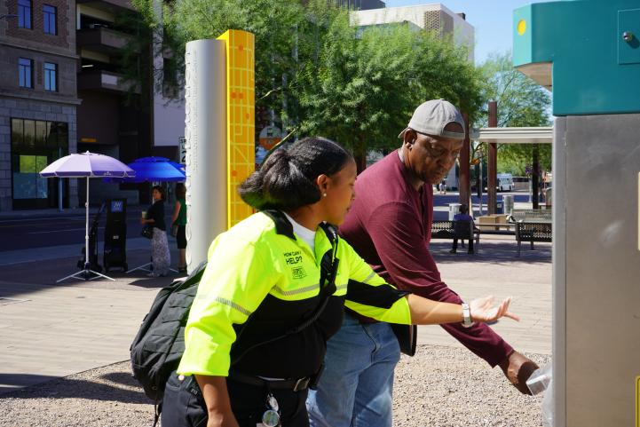 CEC Christina helps a rider purchase a ticket.