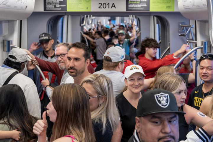Fans enjoy the convenience of riding light rail to SBLVII events in Phoenix Riders on light rail