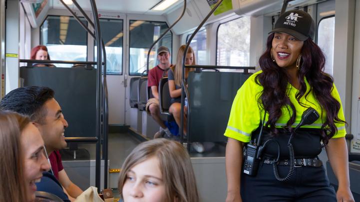 Image showing a Valley Metro customer experience coordinator greeting passengers