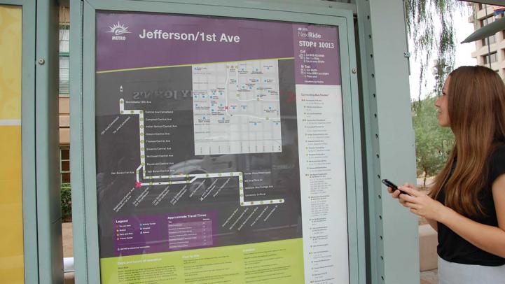 Rider looking at map kiosk with nextride number