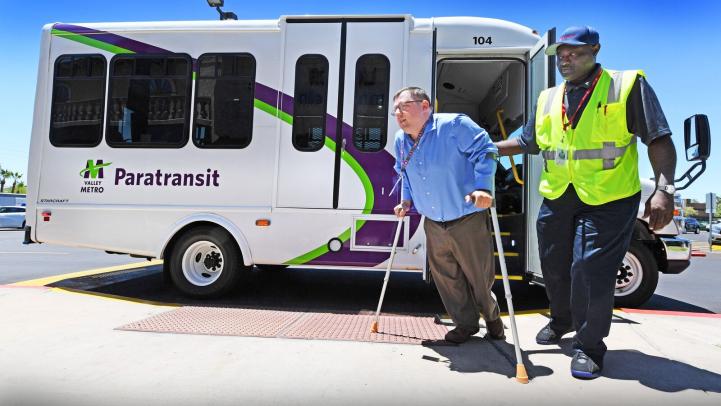 Paratransit driver assisting customer