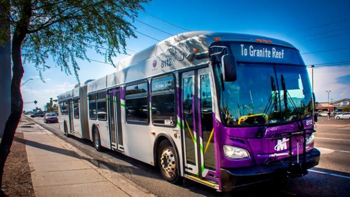 Articulated bus in purple and silver Articulated bus in purple and silver