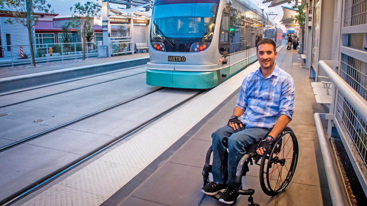 Man in wheelchair on platform as train approaches