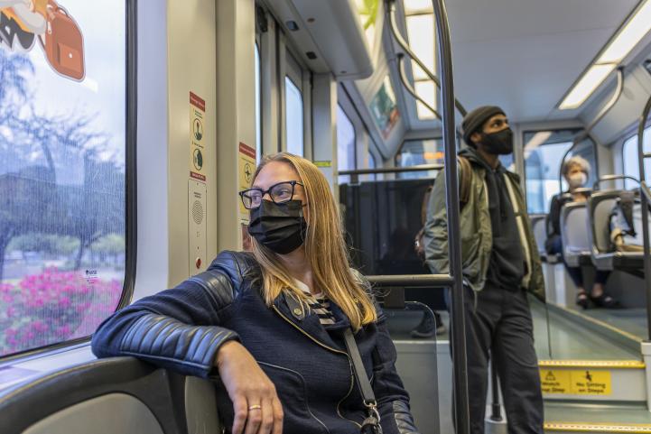 light rail passengers wearing face masks