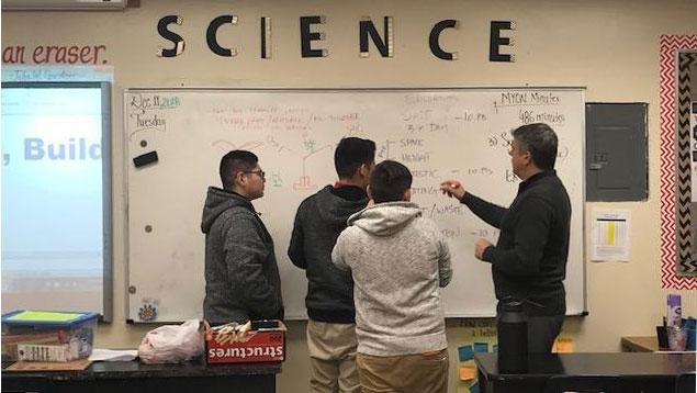 Science students at a white board