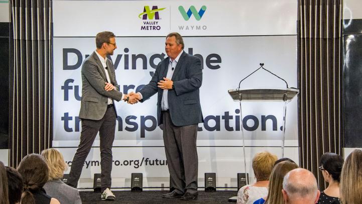 Shaun Stewart, Waymo Chief Business Development Officer and Scott Smith, Valley Metro CEO shake hands.