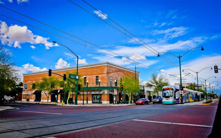 light rail train drives along main street light rail train drives along main street