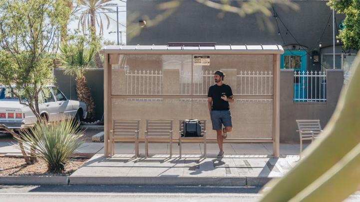 Man waits at bus stop