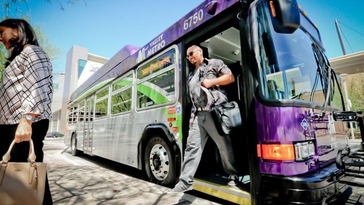Happy passenger exiting a bus