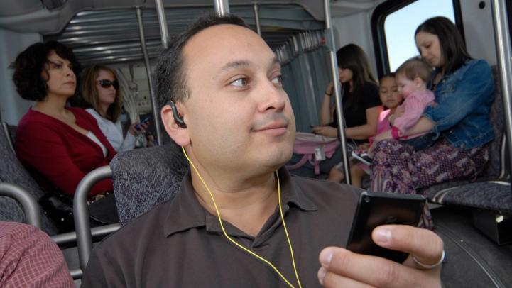 A passenger wearing earbuds