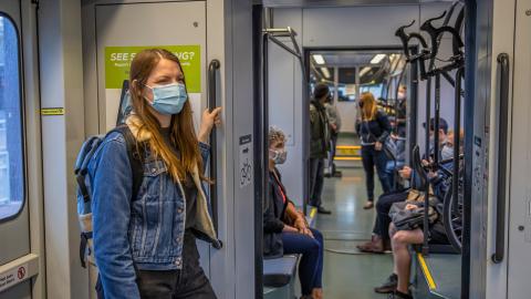 light rail passengers wearing face masks